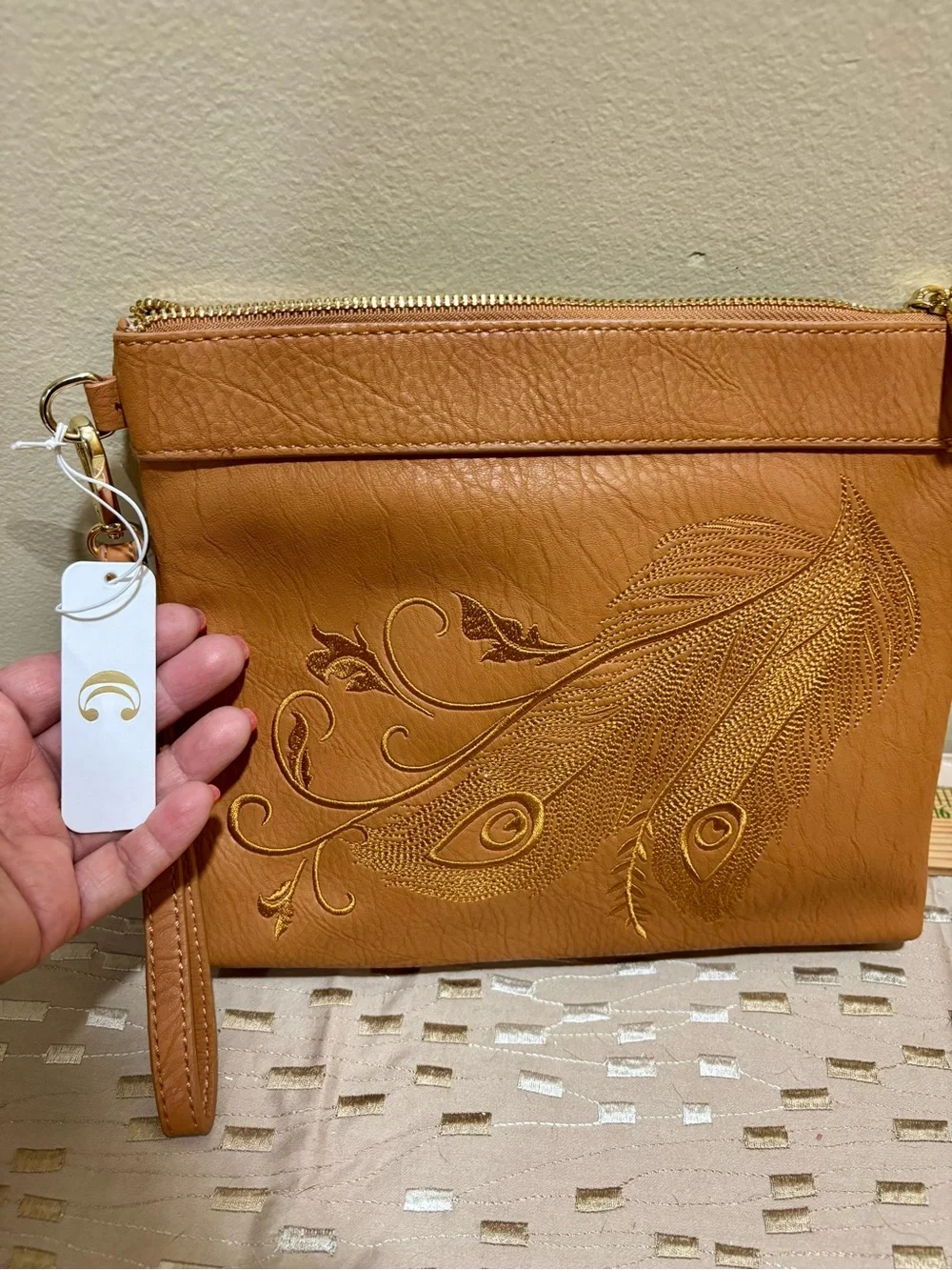Charming Charlie Tan Wristlet Clutch with Embossed Feather Motif